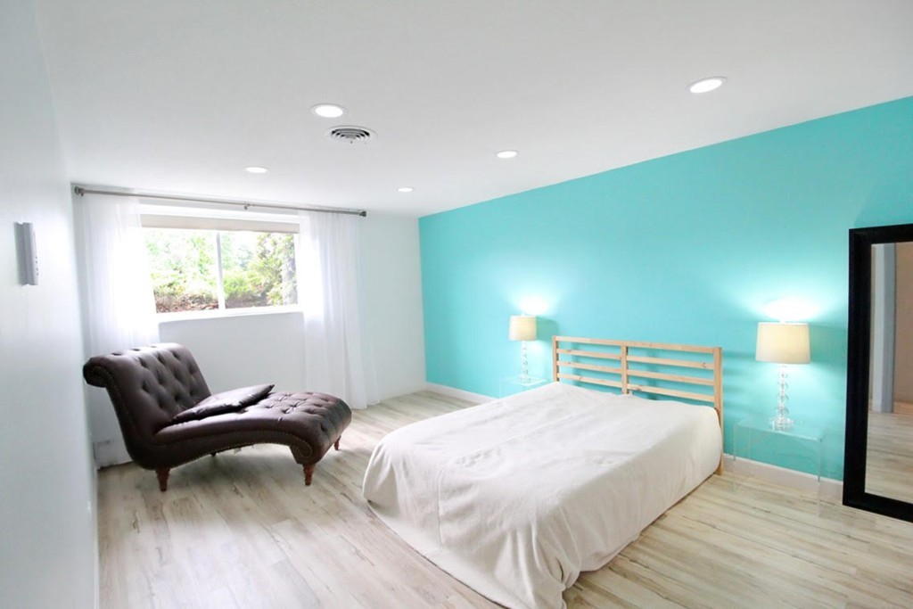 1206 Greendale Avenue, Unit 201 Needham, MA 02492 - Photo 16 of 26 a bedroom with a bed and chair
