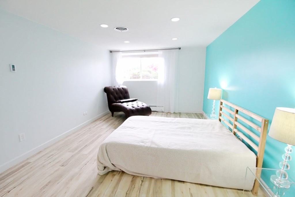 1206 Greendale Avenue, Unit 201 Needham, MA 02492 - Photo 17 of 26 a bedroom with a bed and a window