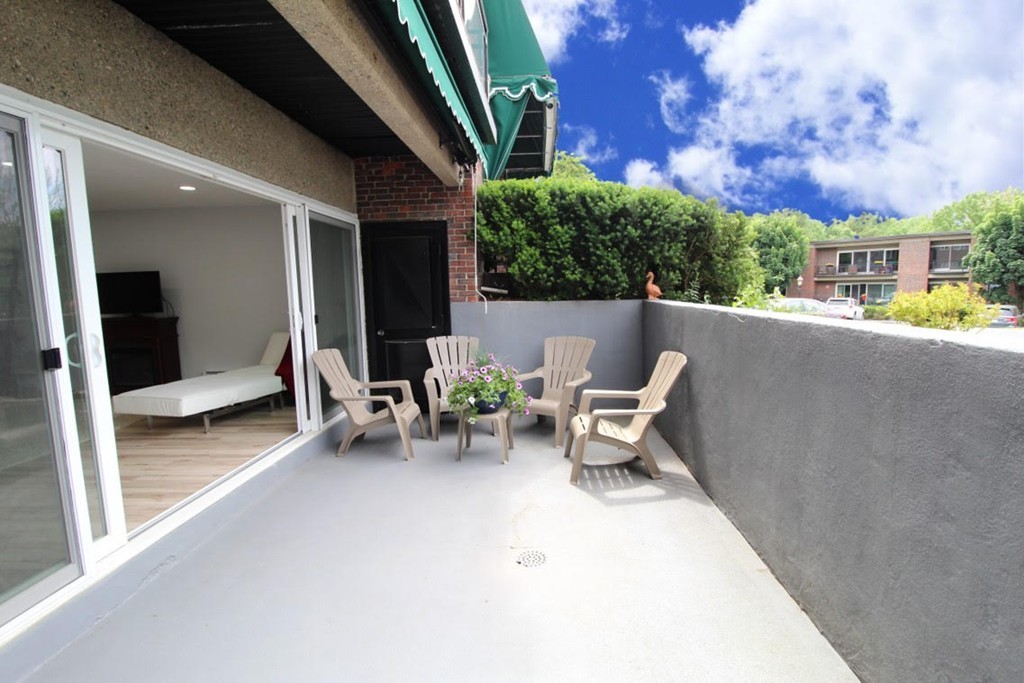 1206 Greendale Avenue, Unit 201 Needham, MA 02492 - Photo 21 of 26 a view of a patio with table and chairs and potted plants