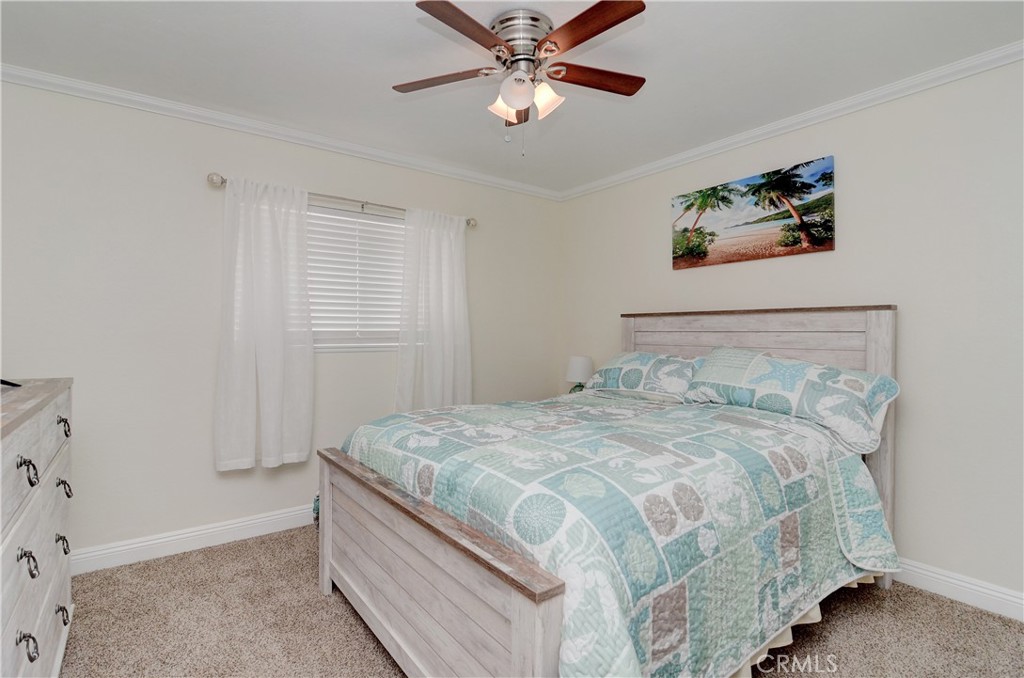 25095 Perch Drive Dana Point, CA 92629 - Photo 20 of 30 a bedroom with a bed and a chandelier
