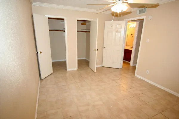 an empty room with windows and bathroom view