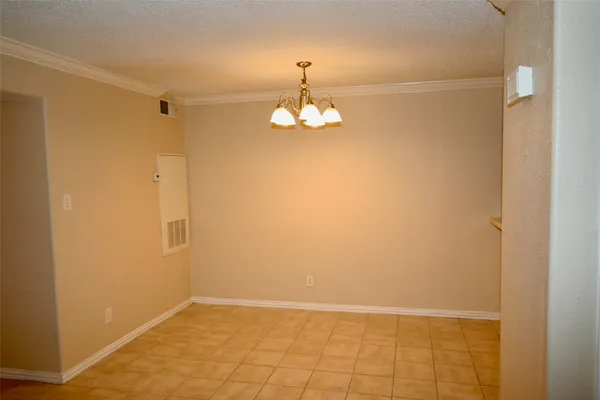a view of a chandelier in big room and chandelier