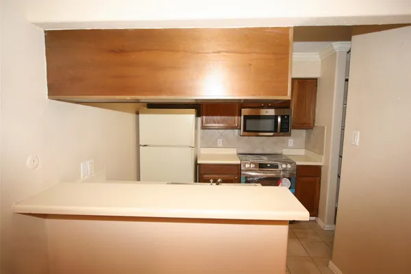 a kitchen with a stove and a refrigerator