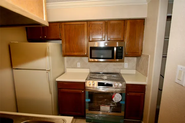 a kitchen with a refrigerator stove and microwave