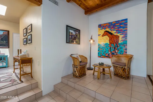 a kitchen with stainless steel appliances kitchen island granite countertop a table chairs and a refrigerator