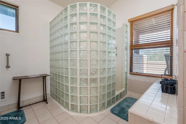 a bedroom with a bed and a night stand