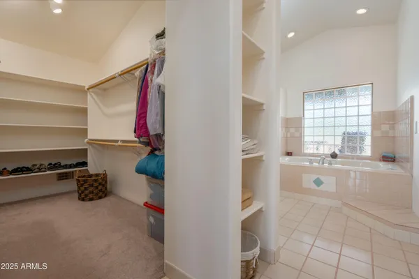 a bedroom with a large bed and a desk