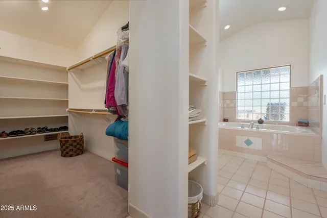 a bedroom with a large bed and a desk