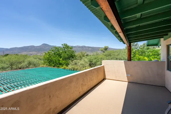 a view of a patio with wooden floor barbeque oven and outdoor seating