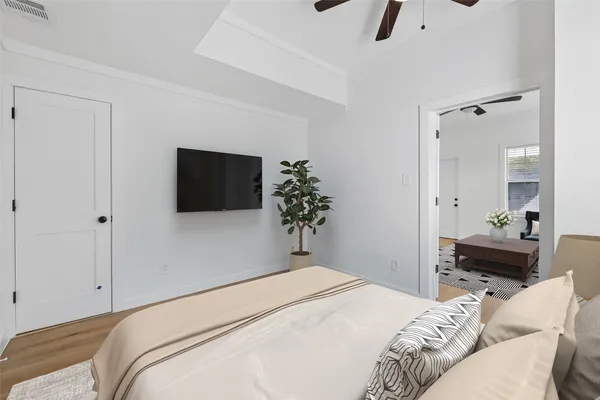 a bedroom with a bed and a flat tv screen