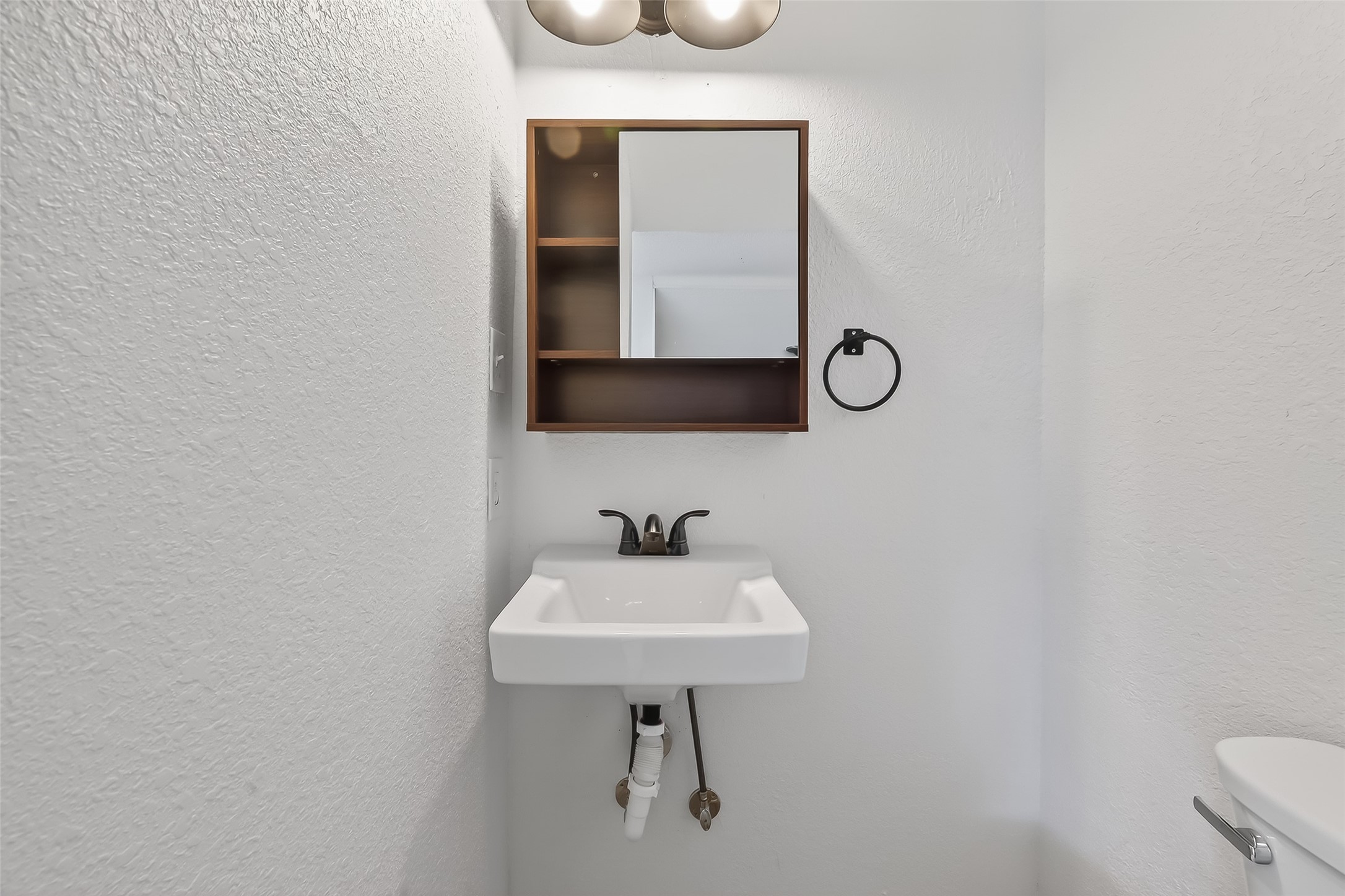 2202 Hutchins Street, Unit A Houston, TX 77003 - Photo 21 of 27 a bathroom with a sink a light fixture and a toilet