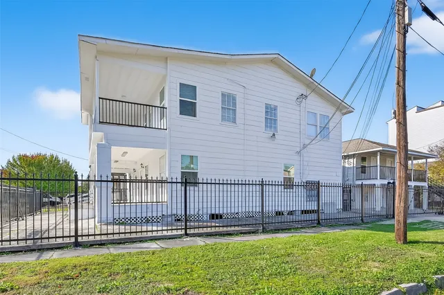 a view of a house with a yard and deck