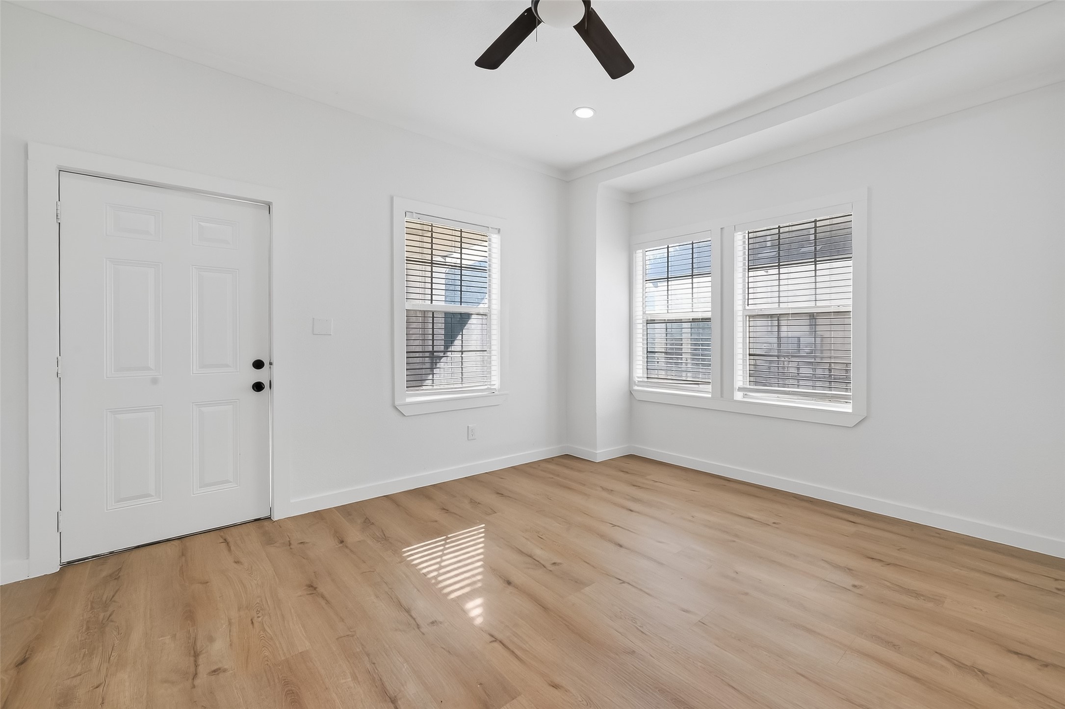 2202 Hutchins Street, Unit A Houston, TX 77003 - Photo 6 of 27 a view of an empty room with window and wooden floor