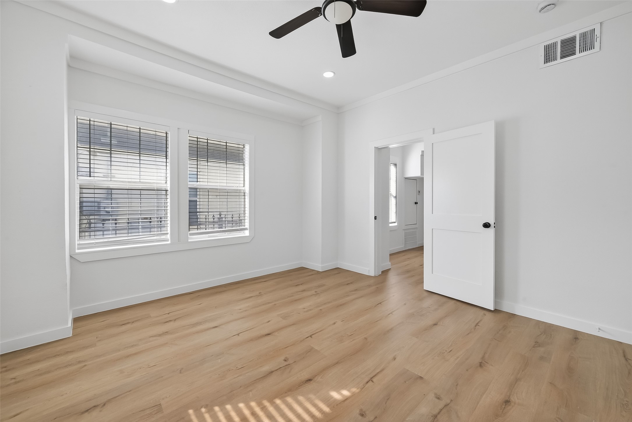 2202 Hutchins Street, Unit A Houston, TX 77003 - Photo 8 of 27 a view of an empty room with a window and wooden floor