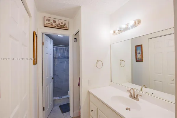 a bathroom with a sink a mirror and a shower
