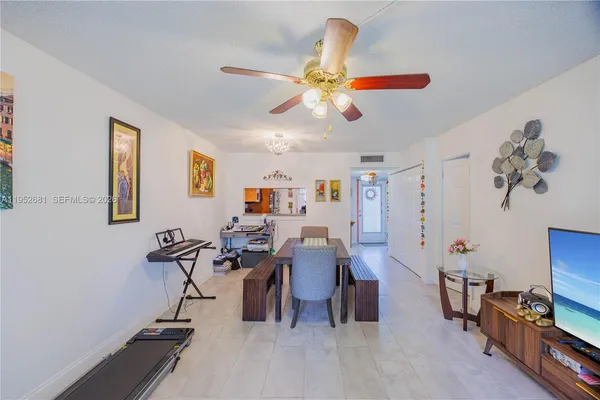 a view of a livingroom with furniture and a flat screen tv