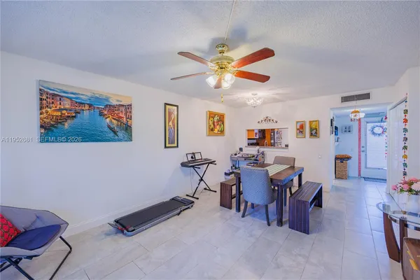 a view of a dining room with furniture and a chandelier fan