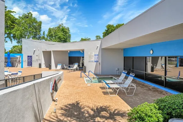 a view of a swimming pool with chairs