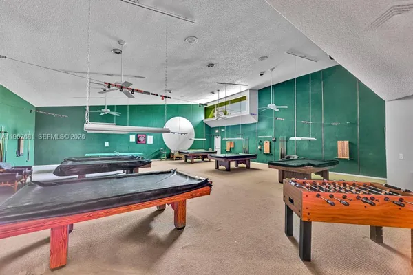 a room with lots of furniture and potted plants