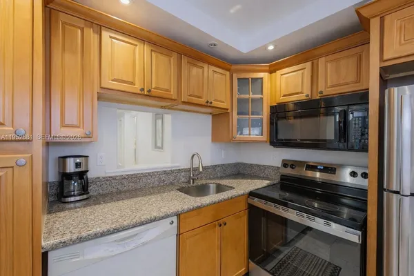 a kitchen that has a sink and a stove