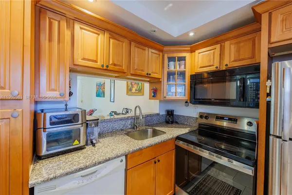 a kitchen with stainless steel appliances granite countertop a stove and a microwave
