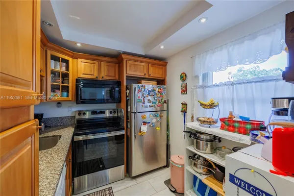 a kitchen with stainless steel appliances a stove a refrigerator and cabinets