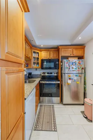 a kitchen with stainless steel appliances granite countertop a refrigerator and a stove