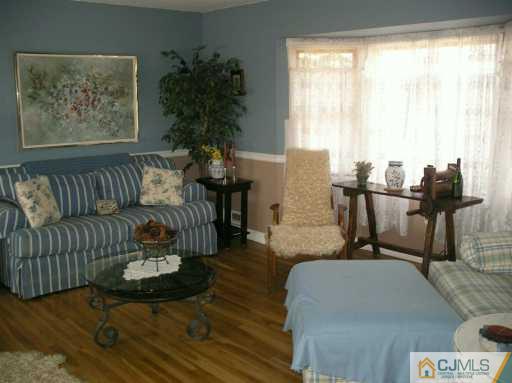33 Meyer Road Edison, NJ 08817 - Photo 2 of 8 a living room with furniture and wooden floor