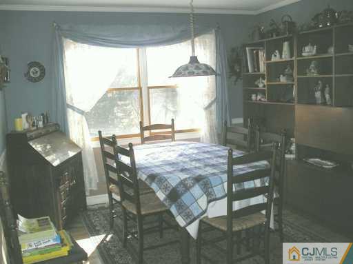 33 Meyer Road Edison, NJ 08817 - Photo 3 of 8 a dining room with furniture and a floor to ceiling window
