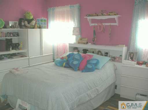 33 Meyer Road Edison, NJ 08817 - Photo 6 of 8 a bedroom with a bed and a cabinets