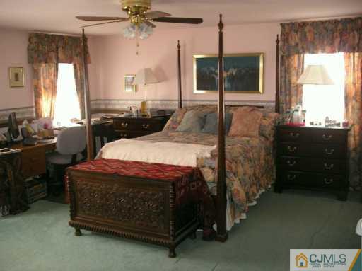 33 Meyer Road Edison, NJ 08817 - Photo 7 of 8 a bed room with a bed window and a dresser