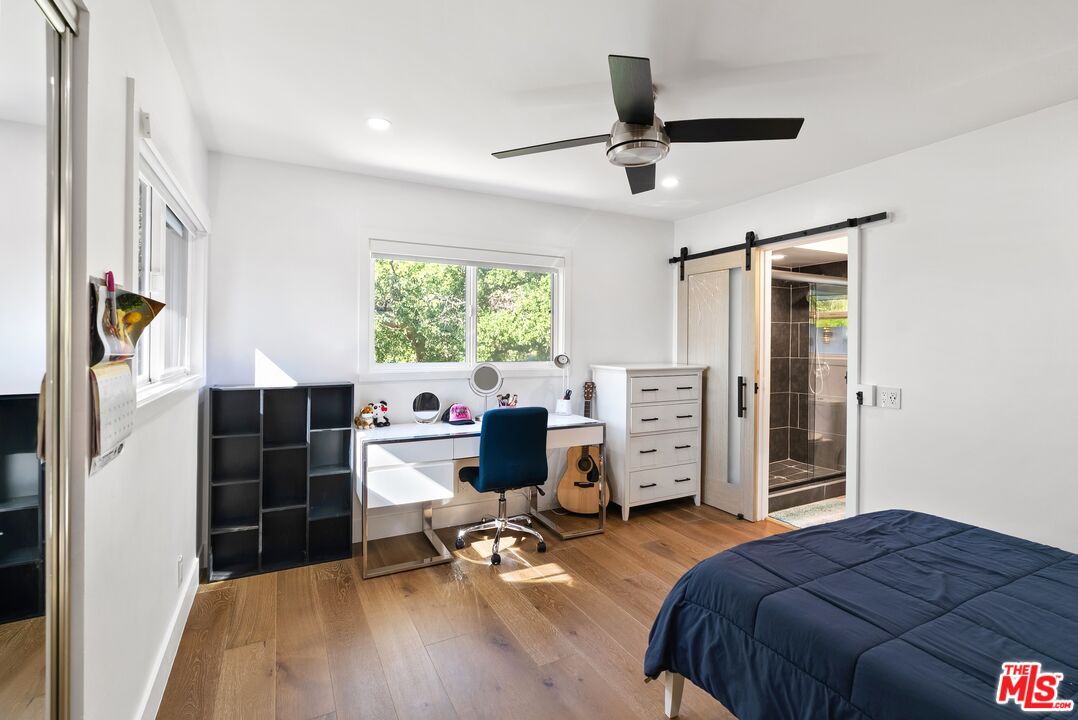 4118 Oak Hollow Road Calabasas, CA 91302 - Photo 49 of 55 a bedroom with a bed and furniture