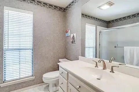 a bathroom with a sink toilet and shower