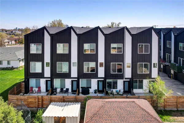 a view of a brick building with many windows and yard