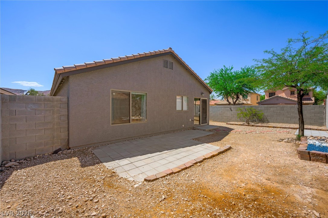 6762 Arapaho Ranch Las Vegas, NV 89148 - Photo 25 of 27 A spacious backyard with a paved patio, ready for personalized landscaping.