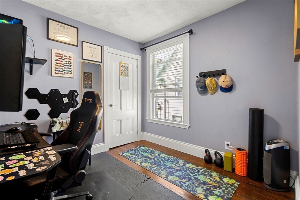 189 Burrill Street, Unit 2 Swampscott, MA 01907 - Photo 11 of 21 a bedroom with a bed and a window