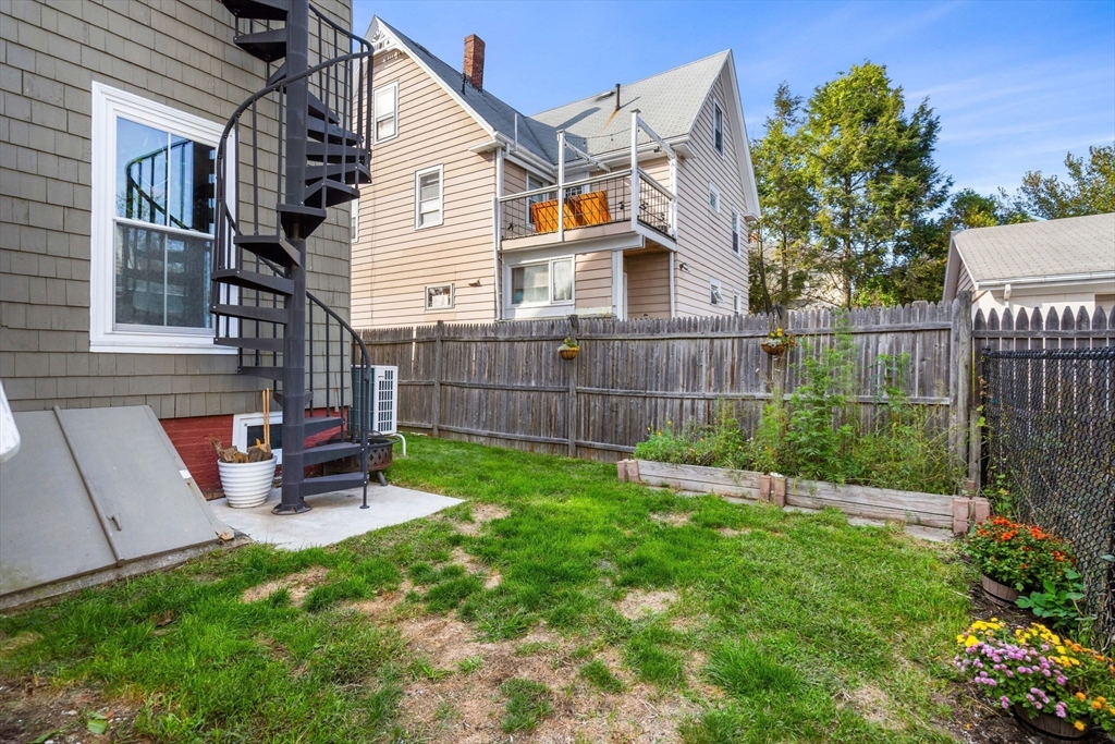 189 Burrill Street, Unit 2 Swampscott, MA 01907 - Photo 15 of 21 a view of a chair and table in backyard of the house