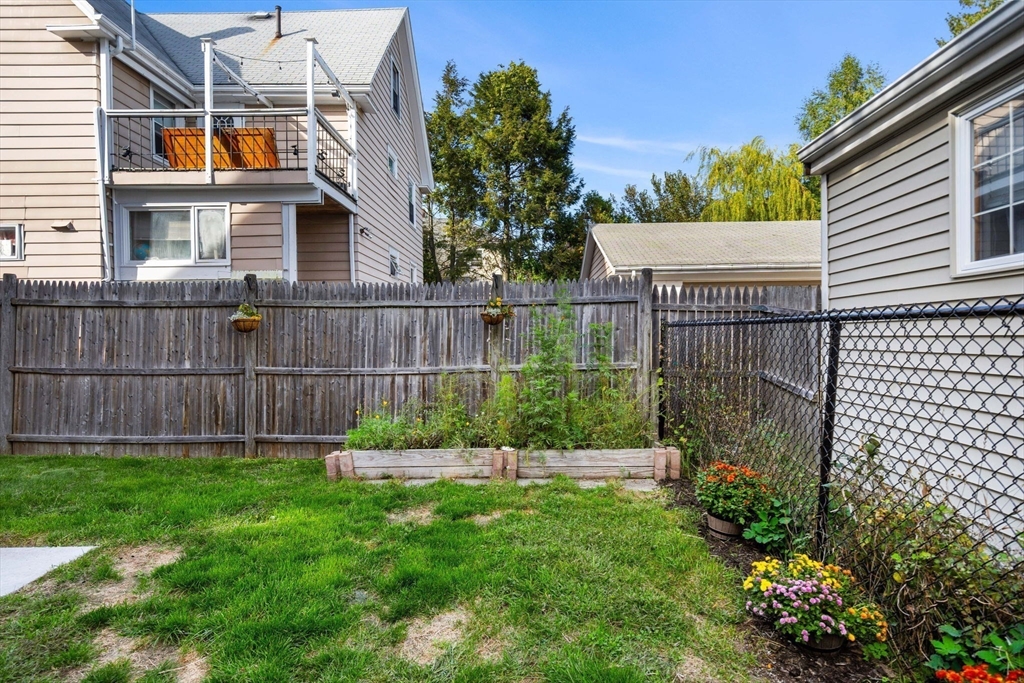 189 Burrill Street, Unit 2 Swampscott, MA 01907 - Photo 16 of 21 a view of a chair and table in the backyard