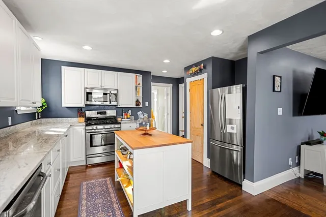 a kitchen with stainless steel appliances a refrigerator stove microwave and sink