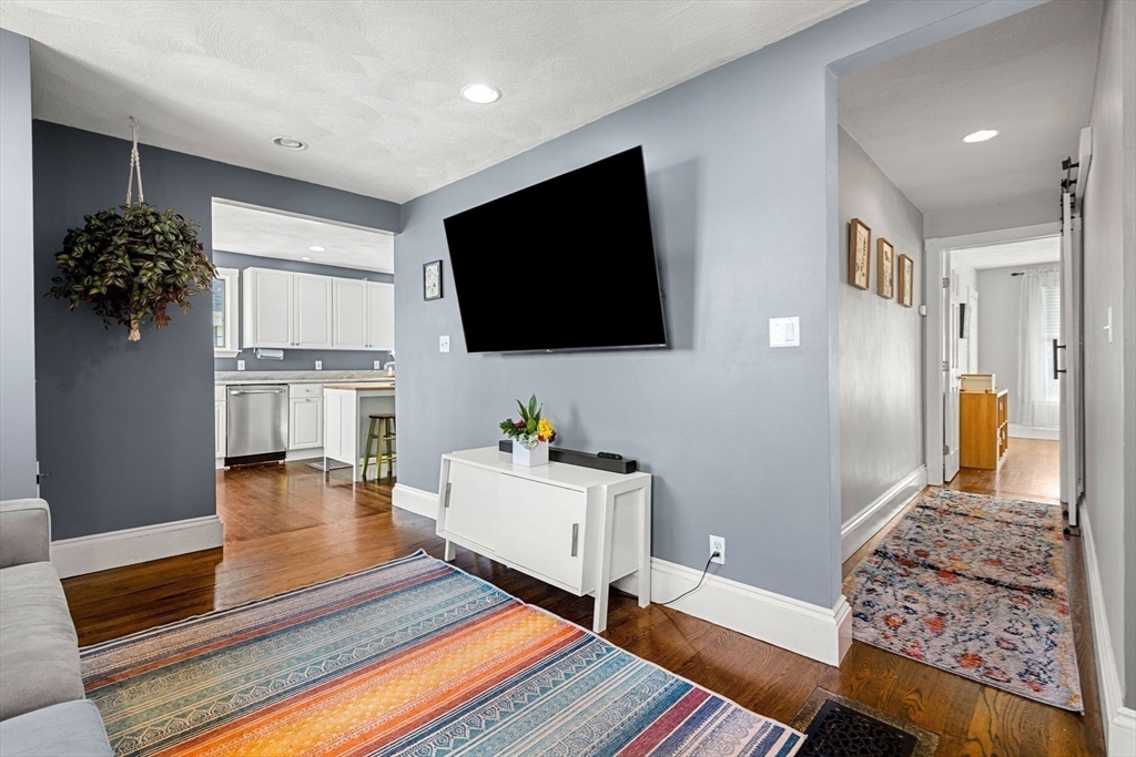 189 Burrill Street, Unit 2 Swampscott, MA 01907 - Photo 6 of 21 a living room with furniture and a flat screen tv