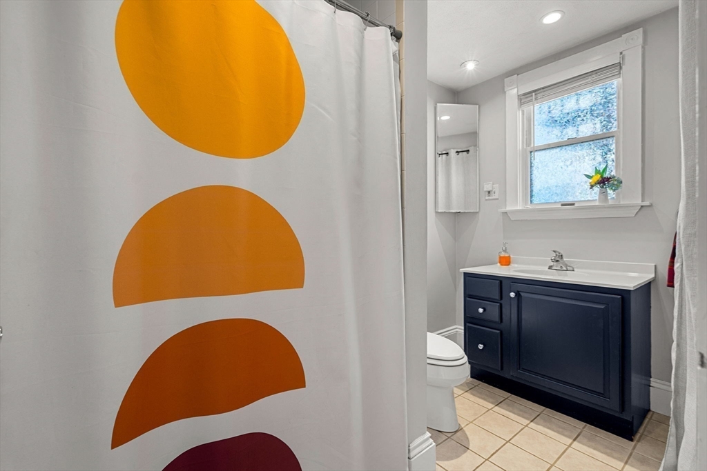 189 Burrill Street, Unit 2 Swampscott, MA 01907 - Photo 10 of 21 a bathroom with a sink mirror and toilet