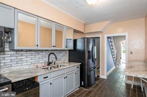 1618 Roundhill Road Baltimore, MD 21218 - Photo 17 of 50 a kitchen with a sink refrigerator and cabinets