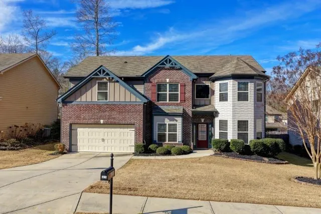 a front view of a house with a yard
