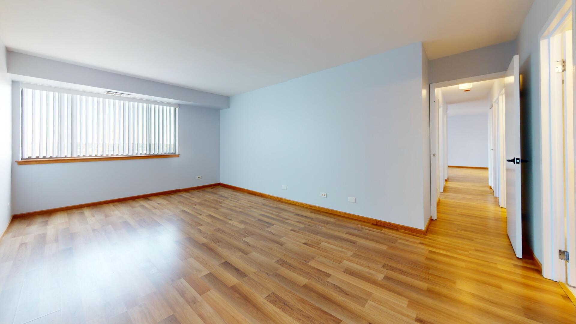 600 Naples Court, Unit 608 Glenview, IL 60025 - Photo 11 of 26 a view of empty room with wooden floor and fan