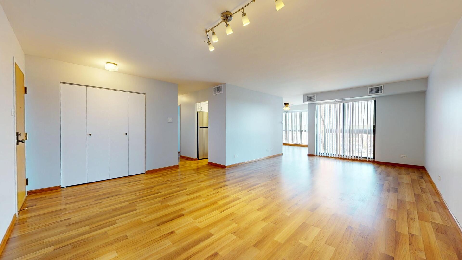 600 Naples Court, Unit 608 Glenview, IL 60025 - Photo 2 of 26 a view of empty room with wooden floor and fan