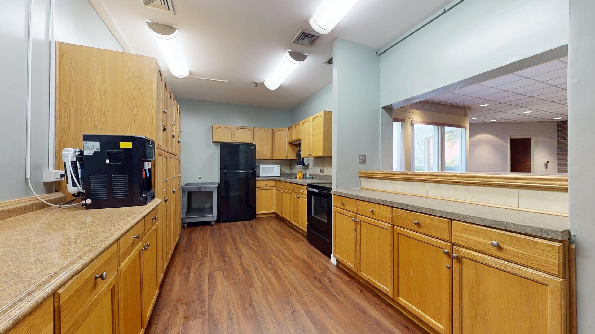 600 Naples Court, Unit 608 Glenview, IL 60025 - Photo 24 of 26 a large kitchen with stainless steel appliances wooden floor and large windows