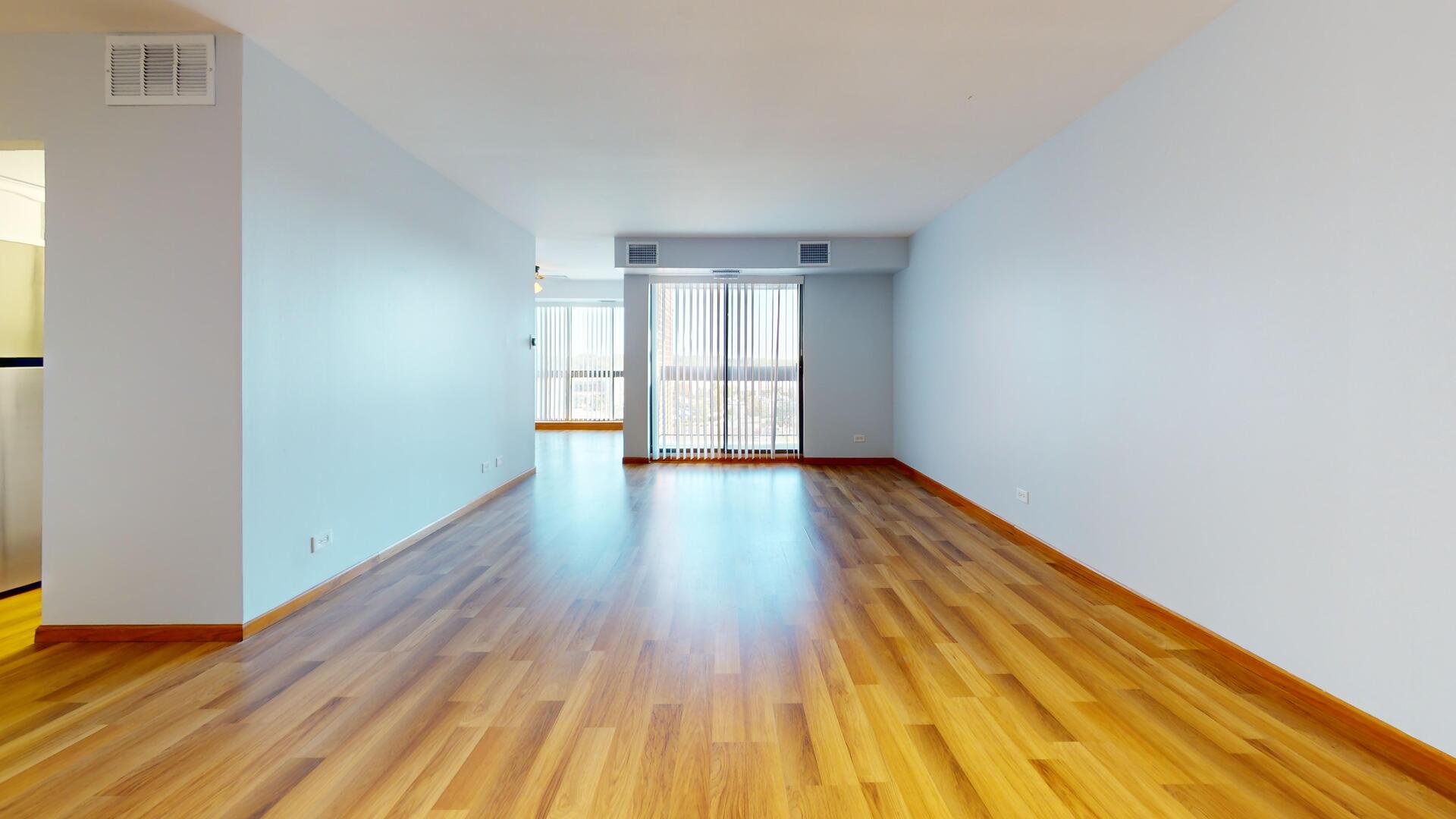 600 Naples Court, Unit 608 Glenview, IL 60025 - Photo 3 of 26 a view of empty room with wooden floor and fan