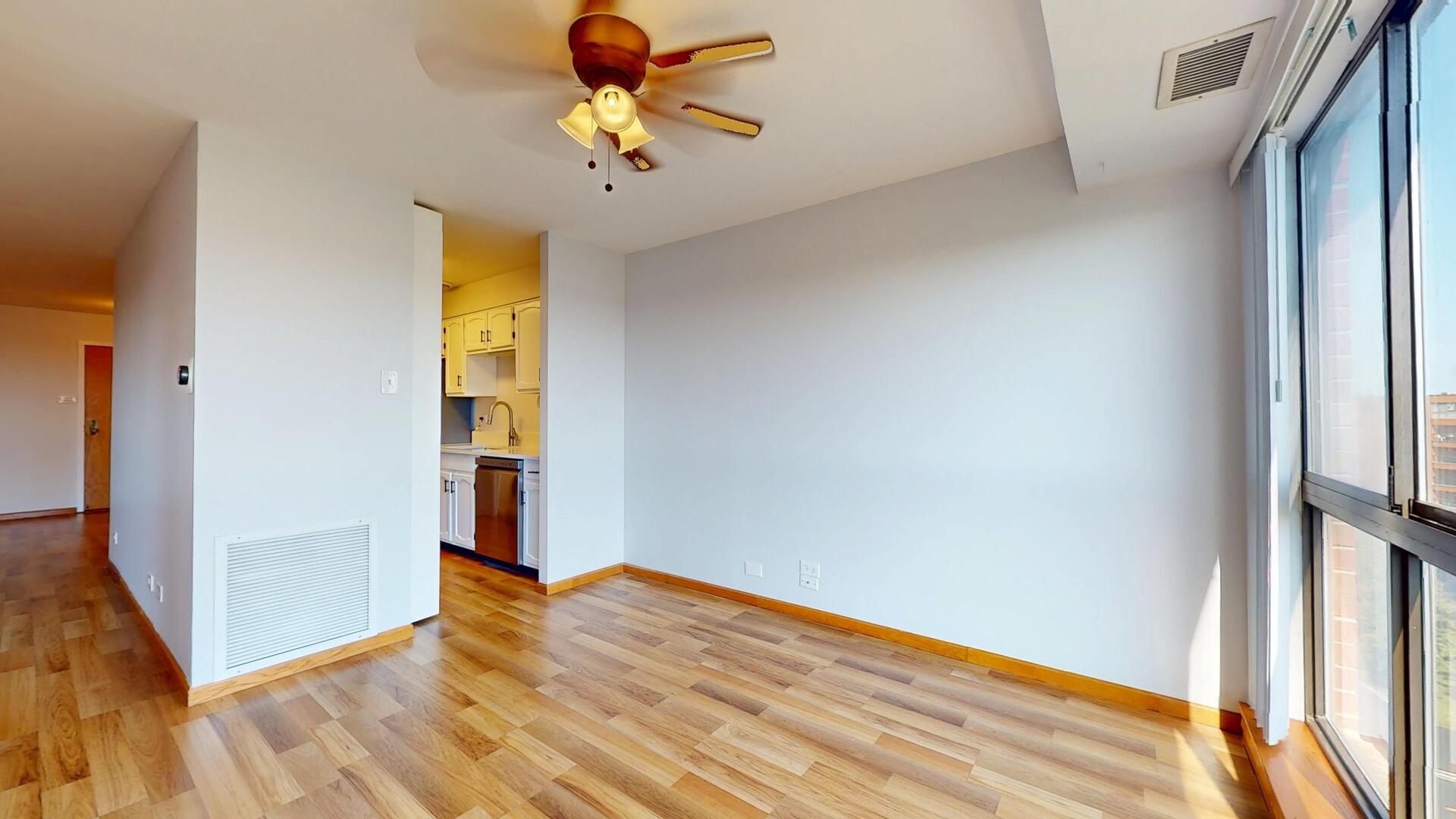 600 Naples Court, Unit 608 Glenview, IL 60025 - Photo 8 of 26 a view of empty room with wooden floor and fan