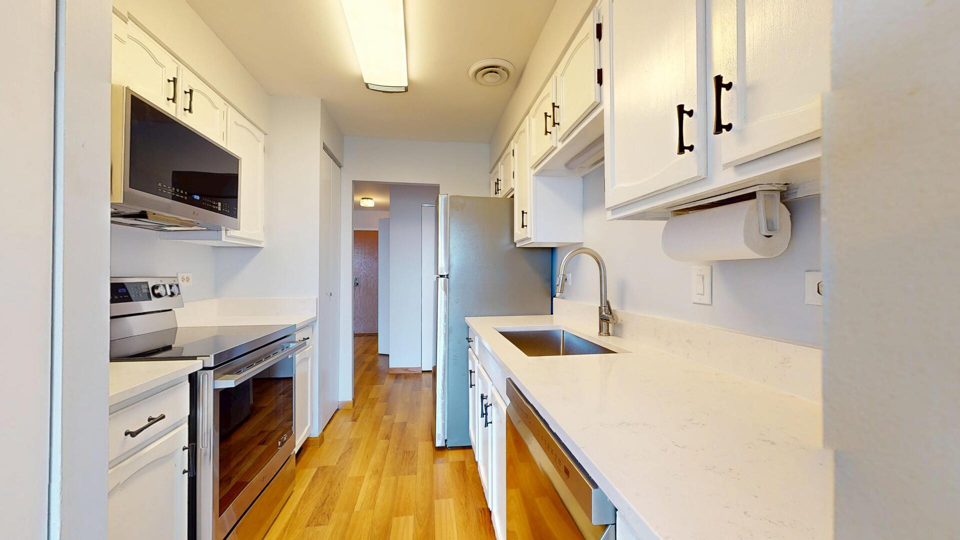 600 Naples Court, Unit 608 Glenview, IL 60025 - Photo 9 of 26 a kitchen with stainless steel appliances a stove a sink and a microwave