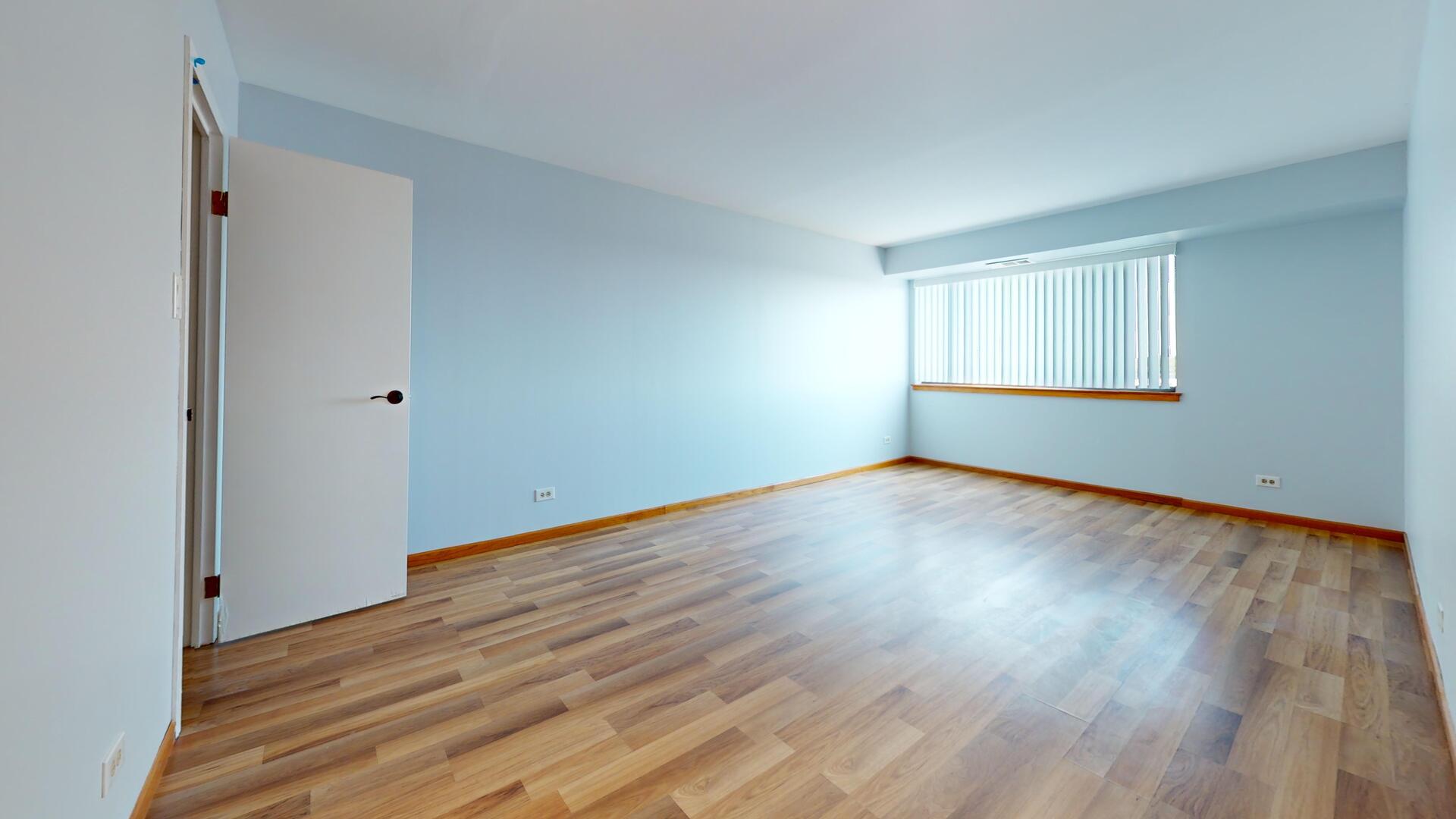 600 Naples Court, Unit 608 Glenview, IL 60025 - Photo 10 of 26 an empty room with wooden floor and windows
